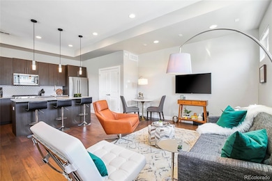 The living room is open to the kitchen and dining area with seating for 3 at the kitchen island as well as the cafe dining table for a more formal dinner.