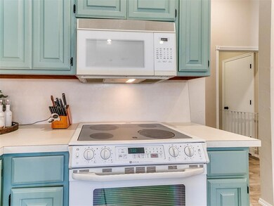 Kitchen featuring white appliances