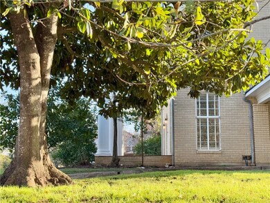 View of side of home with a lawn
