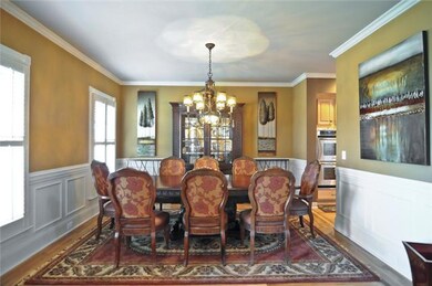 Formal Dining has a beautiful chandelier and good size windows that includes plantation shutters.