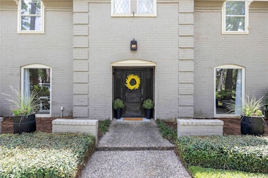 The inviting front entrance is framed by two sleek