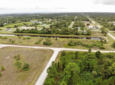Aerial view of property and surrounding area featuring a nearby body of water