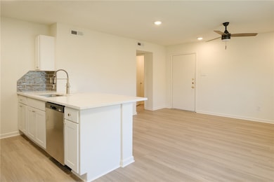 Kitchen featuring white cabinets, visible vents, s