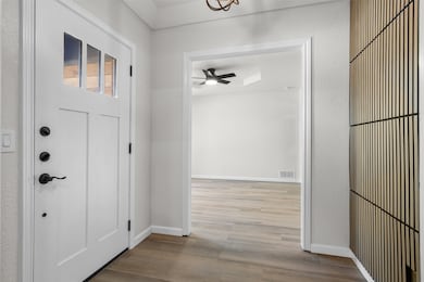Entrance foyer featuring wood finished floors and baseboards