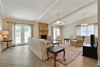 Family room with high ceiling, brick fireplace, ti