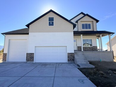 Craftsman inspired home featuring stone siding, a porch, driveway, and a garage
