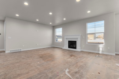 Unfurnished living room with recessed lighting and a glass covered fireplace