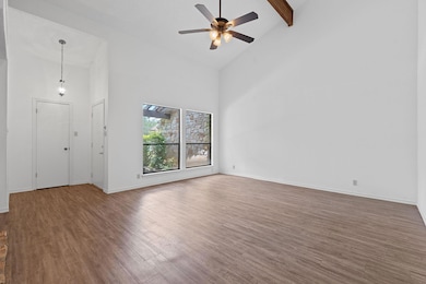 Unfurnished room with wood finished floors, high 