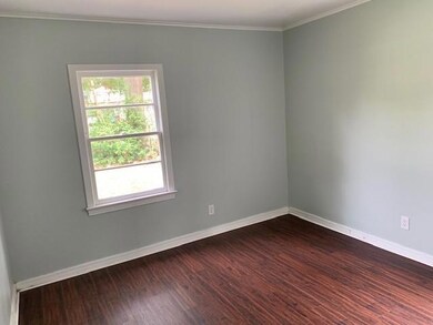 Unfurnished room with crown molding and wood-type 