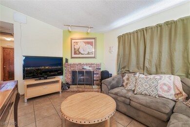 Living room with light tile patterned floors, trac