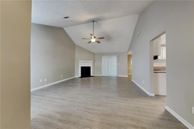 Unfurnished living room with a textured ceiling, l