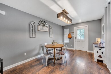 Dining space with dark wood-type flooring