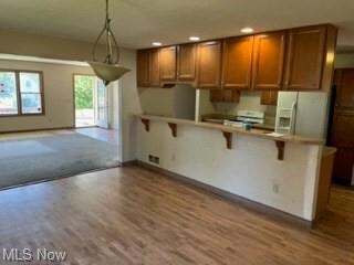 Kitchen featuring white fridge with ice dispenser,