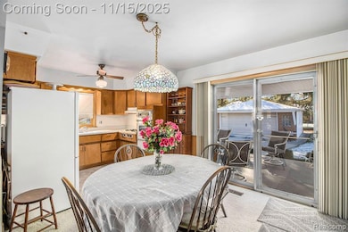 Dining room featuring light carpet and a ceiling fan