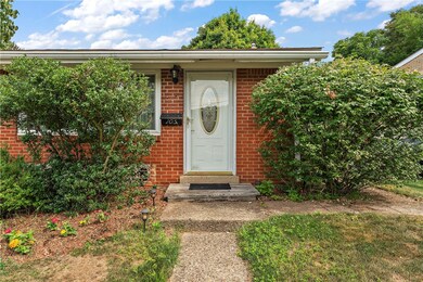 Welcoming front door with storm door.