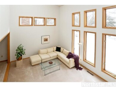 Open floor plan with soaring ceilings and walls of