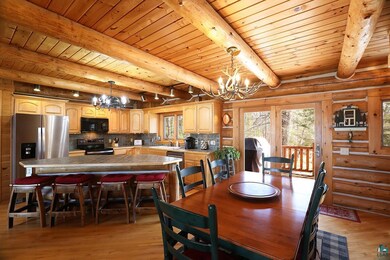 Dining area with a chandelier, wood ceiling, light