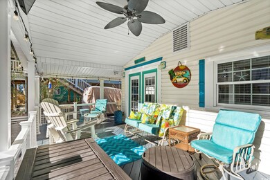 Wooden terrace with a ceiling fan, stairs, and an outdoor hangout area