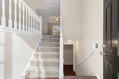 Stairway featuring wood finished floors and ceiling fan