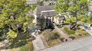 Aerial view showcasing the home’s spacious lot, extended driveway, and mature trees, with the added privacy of having no back neighbors.