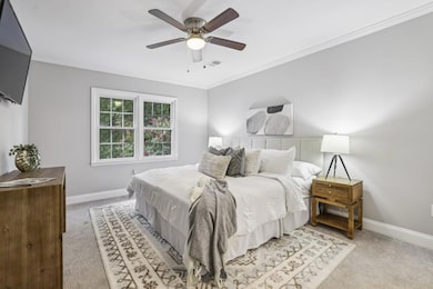 Primary Retreat boasts a Large Ensuite Bathroom with abundant storage, a Stone Double Vanity, and a Spa-Like Glass Shower with Dual Shower Heads and Timeless Subway Tile. A Massive Custom Walk-In Closet completes the suite.