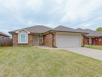 Single story home with a front yard, an attached g