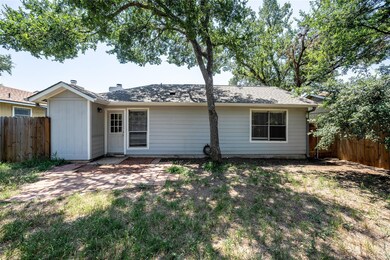 Rear view of house featuring fence