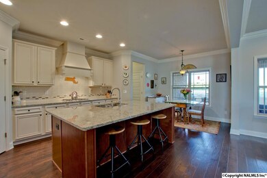 Wood flooring flows through this kitchen that opens to the great room.