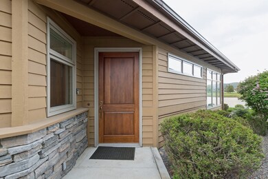 Entrance to property with stone siding