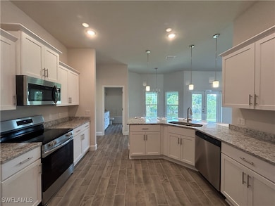 Kitchen featuring stainless steel appliances, a si