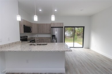 Kitchen with brown cabinetry, modern cabinets, app