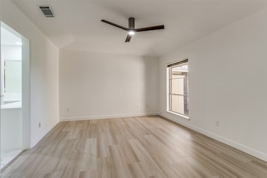Empty room featuring light wood-style floors and a ceiling fan