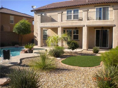 Exterior Back. Covered patio and Balcony off the M