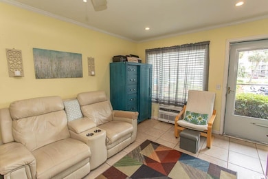 Living room featuring light tile patterned floors, ornamental molding, ceiling fan, recessed lighting, and a wall unit AC