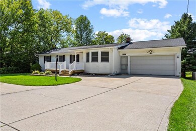Single story home featuring garage, a porch, and a
