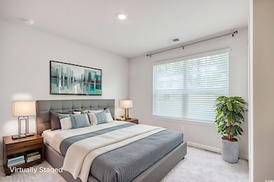 Carpeted bedroom featuring baseboards