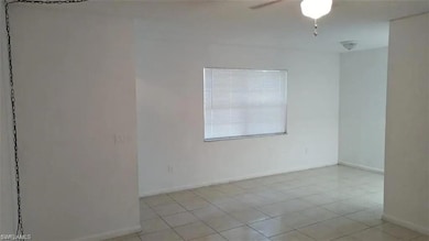 Spare room with ceiling fan and light tile patterned floors