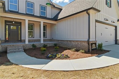 Property entrance featuring a porch, a shingled ro