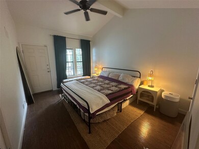 Bedroom featuring dark wood-type flooring, lofted