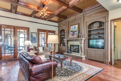 Warm tones & textures & a breath taking coffered ceiling featuring stamped copper, make this living room a favorite for intimate gatherings. Or, fling open the 2 sets of double doors to extend the party to the outdoor living room!