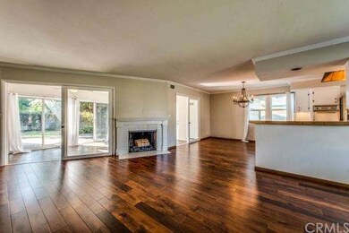 Open floor plan and wood burning fireplace in livi