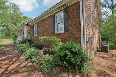 View of side of home featuring brick siding and co