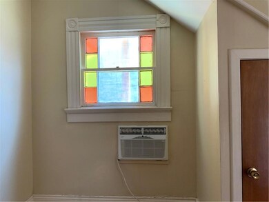 Cozy Bedroom has original stained glass windows...