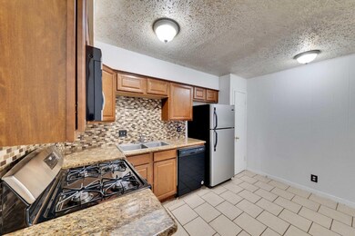 Kitchen with stainless steel appliances, a sink, 