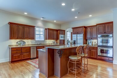 Rich cherry cabinets with Cambria quartz tops. Lar