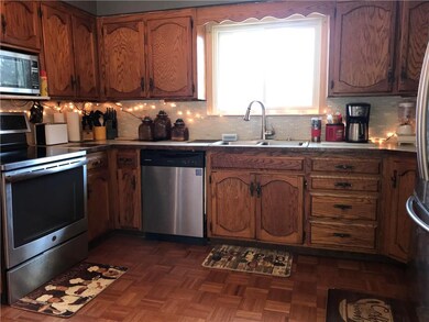 Updated stainless appliances including refrigerator.  Newer gooseneck faucet and kitchen sink window. Pretty parquet floor. Under cabinet lighting plus a touch of twinkling Christmas lights!