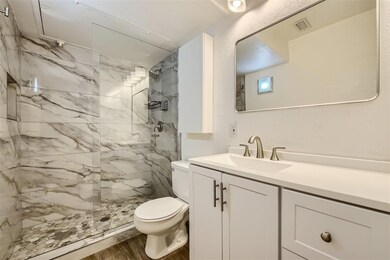 Bathroom with a tile shower, vanity with extensive