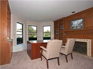 main floor library with woodburning fireplace, bay