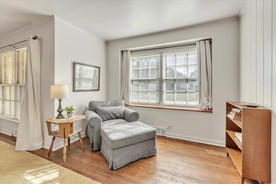 Sitting area off of living room featuring wood flooring
