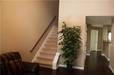 This is the Great room.  Noticed the wonderful hardwood floors, and there is a vaulted ceiling overhead.  Upstairs there are two bedrooms and a laundry room.  Straight back your find a fabulous kitchen bedroom, bathroom, and a patio.